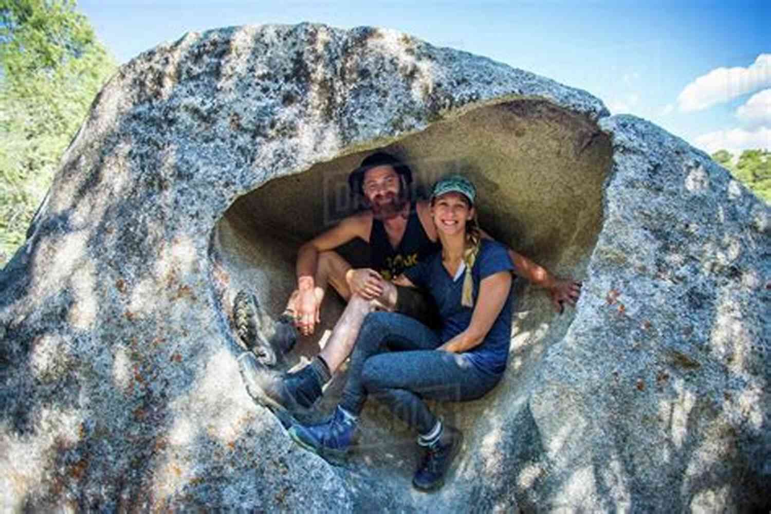 A Couple Sitting On A Rock Formation By The Ocean Romantic Things: A Tree A Rock A Cloud